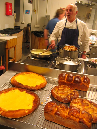 [20050910_005_Kitchen.jpg]
Jean-Louis at battle station, preparing the saturday night dinner while the next morning delicacies are cooling off, right out of the oven.