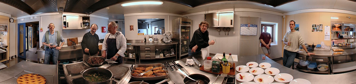[PanoKitchen.jpg]
Aperitif time in the kitchen where Roberto, Emanuele, Michel, Michel and Pascal are having a close look at what Jean-Louis is preparing, glass in hand. Third floor of the noisy building and lifeline of the station.