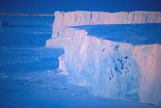 [GlacierWinter.jpg]
In summer the tides and sea currents tend to move icebergs around quite a bit. In winter, the hundreds of km of sea-ice surrounding the continent act as as damper on the water motion, thus no more moving icebergs, they stay put for the duration of the winter like those icebergs from the edge of the Astrolabe glacier.