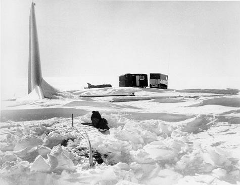 [jd321f.jpg]
Trying to enter through the top hatch of 321 to asses damage inside. The vehicles are from the French Polar Expeditions after a long land traverse from Dumont d'Urville.