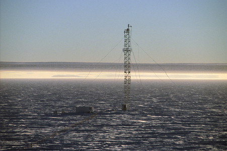 [MirageAmericanMast.jpg]
Another mirage effect, here limited to the deformation of the guy lines holding the tower upright: they should obviously be straight. The white pools in the back are actually reflections of the sky on a very low inversion layer. And the horizon is much higher than it should, up to the point that we get an impression of vertigo, of being inside a large hole.