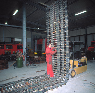 [Chains.jpg]
Antonio working on changing the broken bars and rusty bolts of the chain of a snowcat in the workshop of BTN.