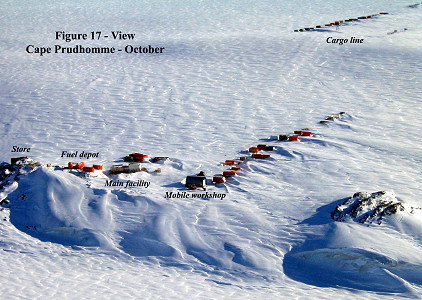 [Godon-023.jpg]
Aerial view of Cap Prud'Homme, departure site of the Traverses, at the end of the winter. The frozen sea is at the bottom of the image. Containers and vehicles not hidden in the underground garage are lined up to minimize wind-drift snow accumulation. (Photo courtesy P. Godon)