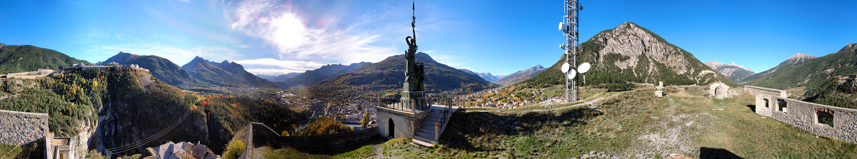 [20061024-FortressStatuePano.jpg]
360° panorama of Briançon from the summit of the fortress. The valley below the sun leads to Argentière, Montdauphin and the Queyras. Behind the statue is the start of the ski area named the Prorel. On the right of the antenna is the Toulouse Crux, a classic mountain bike tour and minor climbing area. The pass on the right is the Montgenevre, leading to Italy.