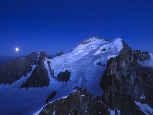 Moon rising behind the Barre des Écrins at night
