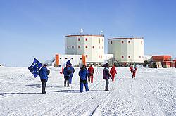 DepartureFlags - Flag bearers walking towards Concordia on the day the winterover starts.