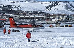 McMurdoAirstripWalker - An italian expedition member, dressed in typical red garb, with the many McMurdo buildings in the background.
[ Click to go to the page where that image comes from ]