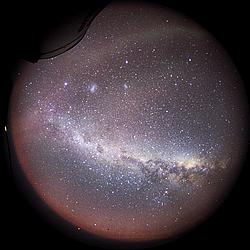 MilkyWayFV_ - The Milky Way seen over the 180° horizon of the Dome C sky. The camera equipped with an 8mm fisheye lens was fixed to a telescope to allow for a few minutes of exposure. The telescope is visible on the upper left of the image and the band next to it is a faint aurora. The two white blurs are the Magellanic clouds. The dark area on the Milky way is called the Coal Sack and is a typical southern hemisphere feature, quite visible to the naked eye. The reddish lower part is light from the sun, still way bellow the horizon but shining nonetheless.
[ Click to download the free wallpaper version of this image ]