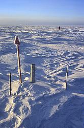 PlaceMarkers - One in a series of several surface markers used to regularly measure the movement of the ice. Dome C is defined as the top of the local ice, but it's so flat that it's easier to define it as the place from which the ice flows in every direction, which is more interesting to deep drilling glaciologists. The station is visible far away on the horizon from this reference pole used yearly by specialized GPS equipment to pinpoint to flow of ice to within a few cm a year horizontally.
[ Click to go to the page where that image comes from ]