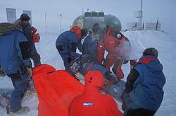 RescueOutside2 - Rescue drill in antarctic conditions: a 'victim' is carried on a sled back to the warmth of the station.