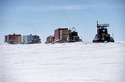 SledTrainArriving1 - Vehicles on the last leg of their long journey before reaching Dome C. They are partly hidden by the wall of snow built on the side of the track. The two 'energy' and 'living' modules can be seen towards the end.
[ Click to go to the page where that image comes from ]