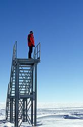 StairsUnused4 - Red man on unused staircase with deep blue sky.