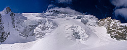 20070507-EcrinsNorthFacePano_ - North face of the Ecrins, with Agostino right under the serac, if still some safe distance away. It takes only 2 minutes to cross under the serac, but it's a very nervous 2 minutes.
[ Click to go to the page where that image comes from ]