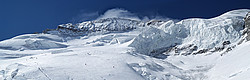 20070507_EcrinsFacePano_ - About 40 people going up and a few already coming down the upper part of the north face of the Ecrins. With a big serac looming above the track.
[ Click to go to the page where that image comes from ]