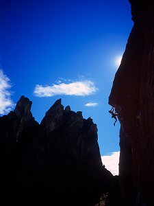 Climber backlit on a hard Smith Rock route