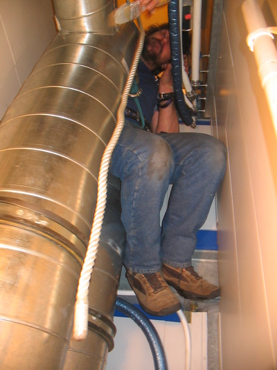 [20050912_018_Tubes.jpg]
Jeff squeezed inside a shaft, installing air conditioning ducts.