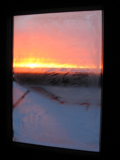 [20051028_006_ColoredWindow.jpg]
Very colorful sunset seen through the partly frozen window on the first day the sun doesn't actually set.
