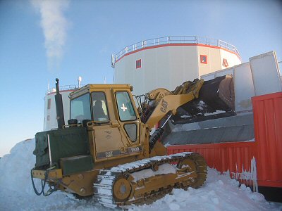 [FillingMelter.jpg]
Jean filling the snow melter, something that needs to be done several times a day, otherwise the level drop down too much or the water heats up too much. The heating is provided directly by the power generator.
