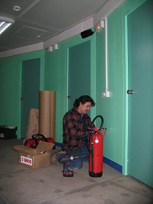 [FireExtinguisherGreenFloor.jpg]
Jeff installing fire extinguishers at the bedroom floor of the quiet building.