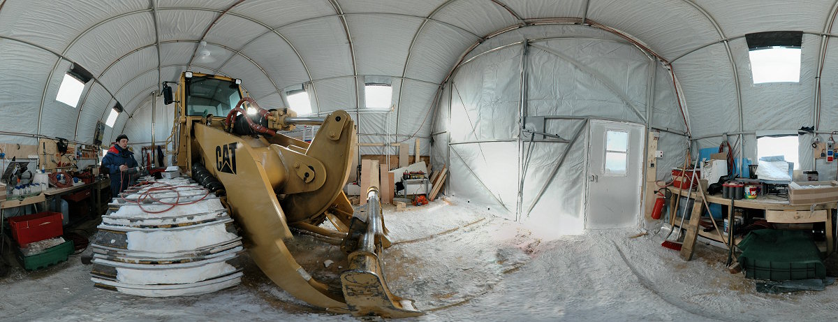 [PanoGarage.jpg]
Michel in the tent used for multiple purpose: as garage for the large Caterpillar and the few snowmachines useless in winter (hidden behind), as woodworking shed and as weather balloon inflation shed. The helium bottles are out of view behind the Cat as well but we inflate in the small space between the doors and the Cat.