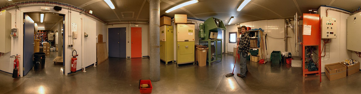 [PanoGarbage.jpg]
Claire sweeping the garbage room floor, located next to the emergency generator room (door on the left). The blue door is the freight elevator, the red door hides the very narrow emergency stairs and the door on the right goes to the fat decantation vats, the first leg of the water recycling system. The two green machines are compressors for plastic and paper while the weirdly shaped other green machine, dubbed the rhinoceros, crushes cans.