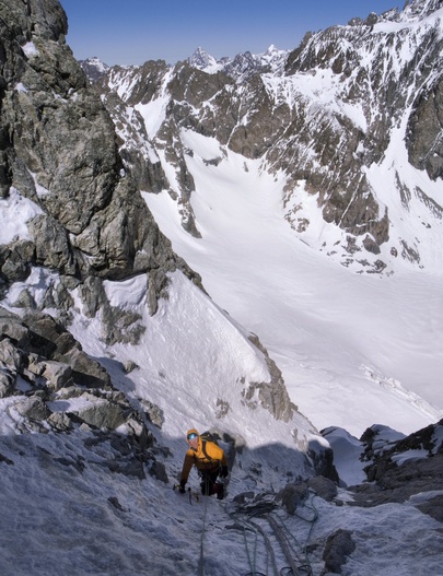 [20070518-114155_JerryEmeraudeVPano_.jpg]
Jerry finishing the 2nd steep pitch of the gully. We found the route in good conditions, the snow was hard on the easier sections and the ice good but thin. At this belay I tried to place 2 screws without success, hitting the rock after a few cm each time, finally settling on using a sling around a rock sticking out of the ice.