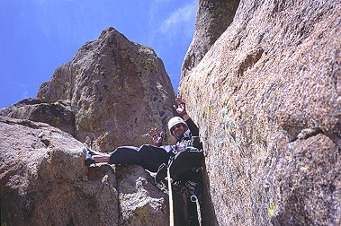 [TurnKorner_NoHands.jpg]
That's me showing off on the crux of Turn-Korner: 5.10+ offwidth roof ? Bah, don't need no stinking hands... This route is another of the excellent long routes of Mainliner at the far end of Lumpy Ridge. The crux is a roof offwidth which is not so bad, provided you have a bunch of large cams. There's also a hidden hold somewhere, which you can see from above after you have completed the moves !