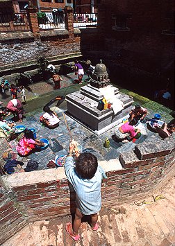 [Washing.jpg]
Since running water must not be a common commodity, most people can be seen washing up and doing their laundry at the many fountains in Katmandu.