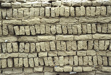 [MudBricks.jpg]
A more common mudwall, worn out by the weather. The ruins of many monasteries can be seen all over Tibet, most of them destroyed during the Cultural Revolution. After the soft mud wall were exposed by the removal of the roofs (fires...), erosion took over very quickly and nowadays hardly anything remains but a few base foundations.
