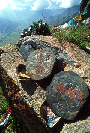 [Rosette.jpg]
On the top of a mountain above Lhasa we saw many votive tablets, most with written prayers carved onto the rock but others with drawings. Some of them have the picture of the owner underneath.
