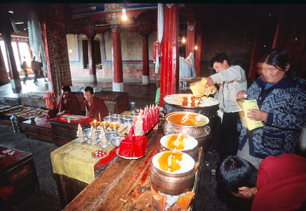 [YakCandles.jpg]
Pilgrims going around a temple with bags of yak/dree butter to refill the candles.