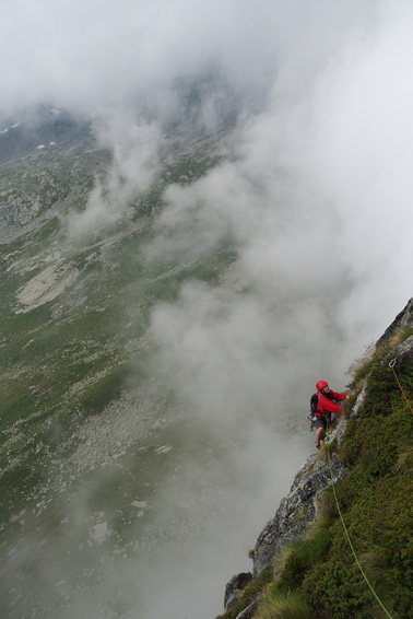 [20110803_162019_WaitingList.jpg]
The last pitch of the route, which you can dispense with: it all loose boulders held together by spiny bushes... And heavy clouds forming up, and is that thunder or a whole bunch of airplanes ? It started pouring as we were rappelling off the last pitch and the wall turned into a waterfall. We expected to be able to relax in the hot thermal spring of Bagni Masino, but they closed 5 minutes before we showed up...