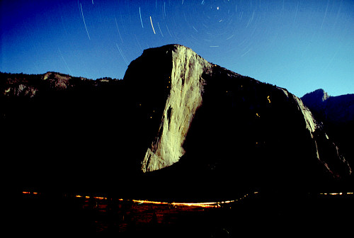 [ElCapMoon.jpg]
El Capitan at night, 1 hour exposure, 50mm/f1.8 at 5.6. The headlamps of the climbers leave a trail of light. It takes some power of will to take such a picture: hike up to the proper spot in the evening with the gear and a sleeping bag, set it up and take a bunch of picture as the night gets darker, increasing the exposure each time: 30s, 1 minute, 3, 10, 30, 1 hour, 3 hours... The non-reciprocity of films in dark conditions makes it so that doubling the exposure does not double the amount of light on the film. Bring an alarm clock.