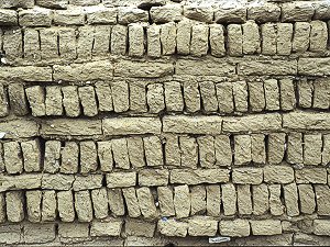 Wall of mud bricks eroded by the weather