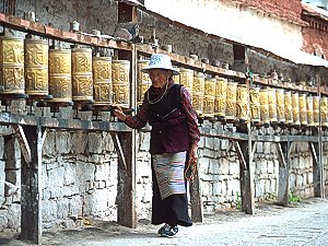 A pilgrim giving a spin to prayer drums