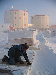 20050816_005_JeanRepair - Jean performing repairs to a sled with a slight haze covering Concordia station.
[ Click to download the free wallpaper version of this image ]