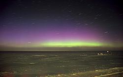 AuroraStarRotation - Faint purple lights in an aurora, above the usual green.
[ Click to go to the page where that image comes from ]