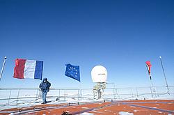 MichelPreparingRoofFlags - Setting up flags on the roof of Concordia.