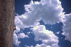 ClimberClouds - Climber against clouds at The Book, Lumpy Ridge, RMNP, Colorado